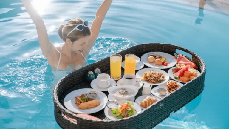 Woman Floating Breakfast in the Tropical Pool